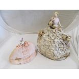 A half-doll as lamp with shell dress, half-doll tea cosy and half-doll book