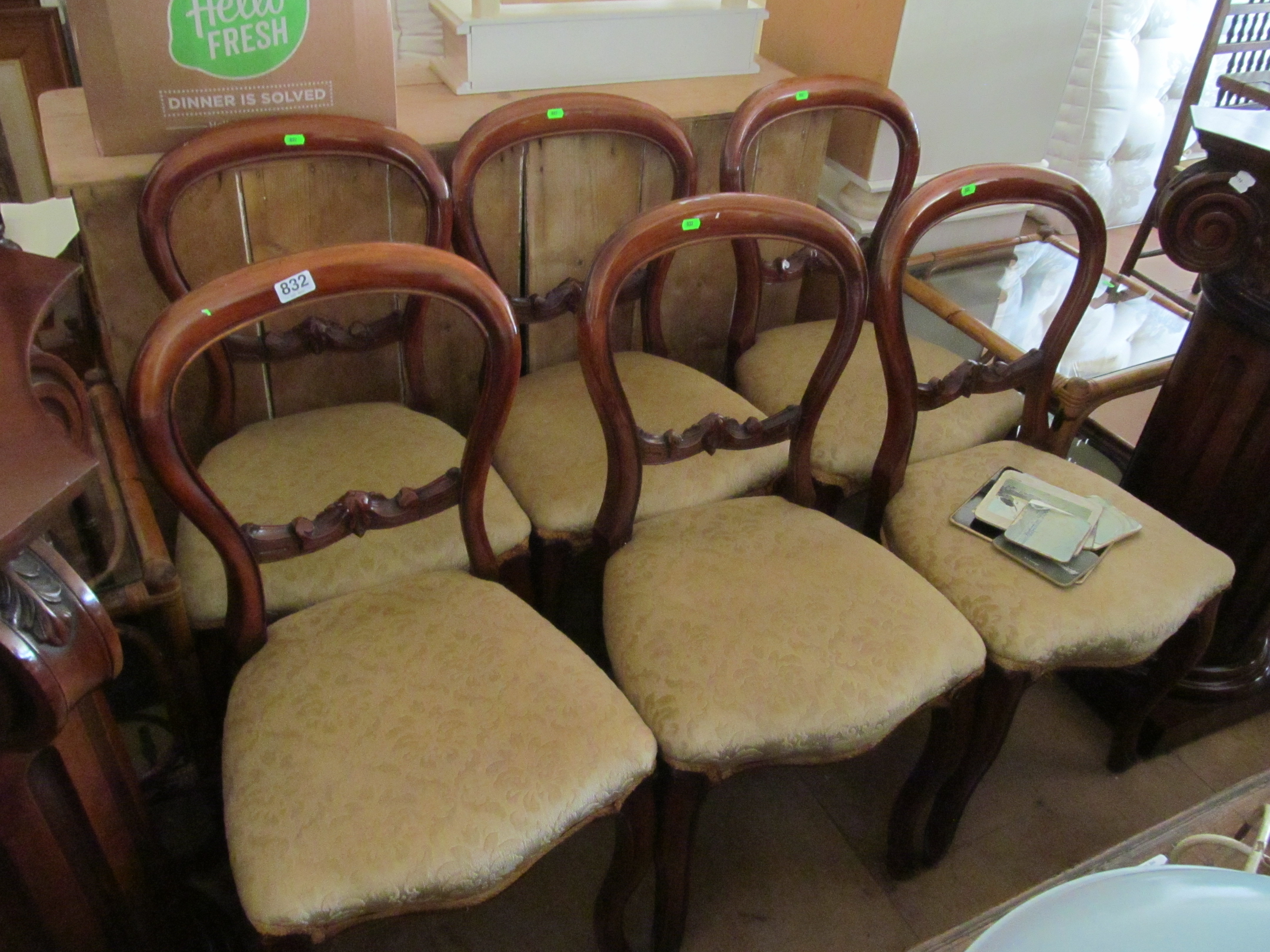 A set of six Victorian mahogany balloon back chairs on cabriole legs