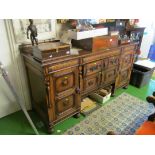 An early 20th Century oak sideboard with two central panelled drawers and two cupboard doors