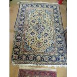 A Persian rug beige ground with blue and salmon pink borders and a similar smaller one