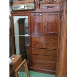 An Edwardian mahogany wardrobe with two cupboards, two small drawers and four long drawers to one