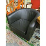 A pair of modern black tub shaped armchairs