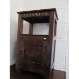 An oak chest of four drawers with carved flower detail, and a matching bedside cabinet.