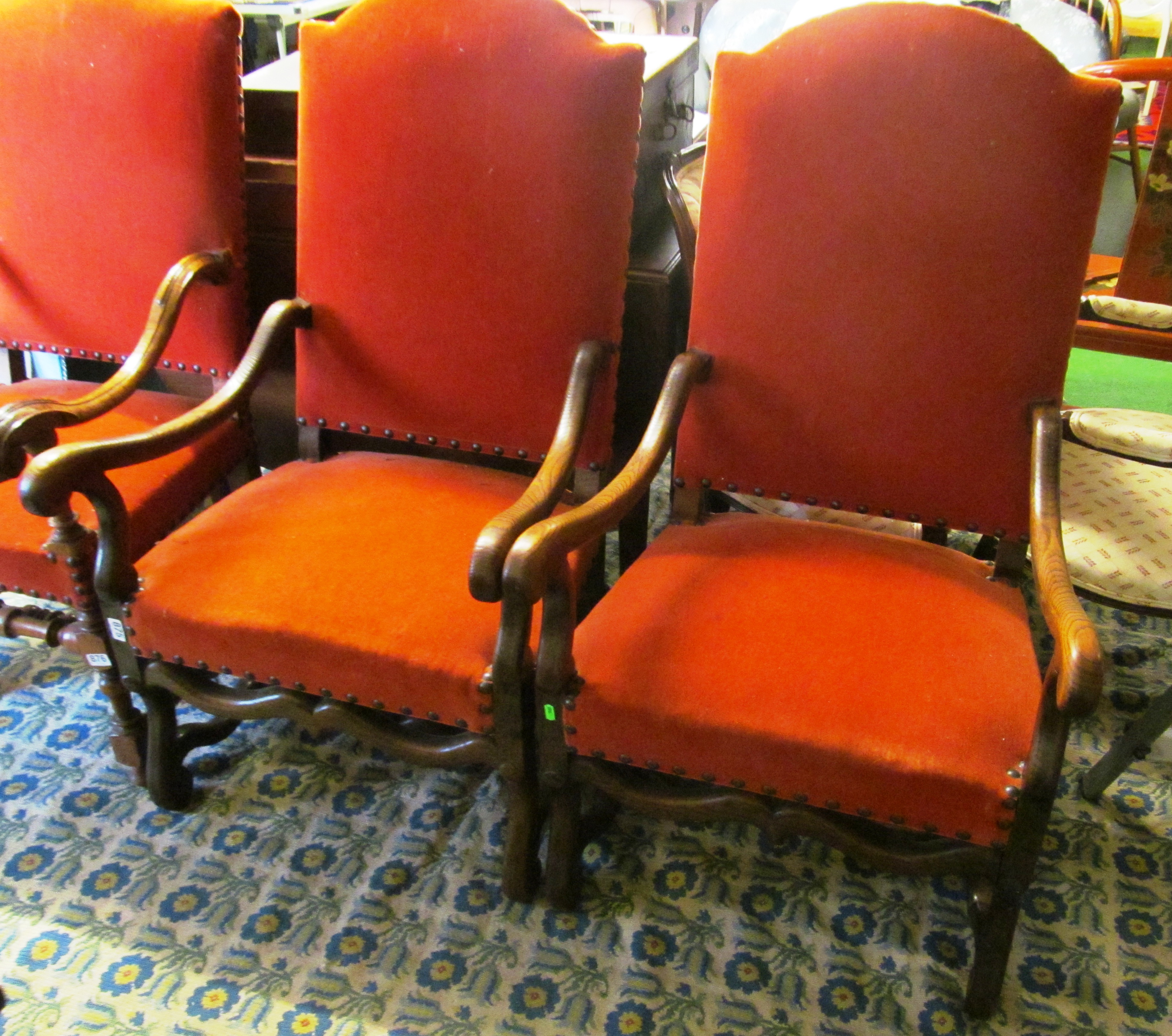 A pair of large oak elbow chairs.