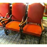 A pair of large oak elbow chairs.