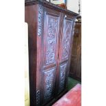 A carved oak wardrobe