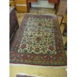 A Kashan style rug cream ground with red, blue and green stylized floral design