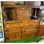 A carved oak court cupboard.