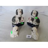 A pair of Staffordshire dogs and puppies on blue bases and another smaller pair