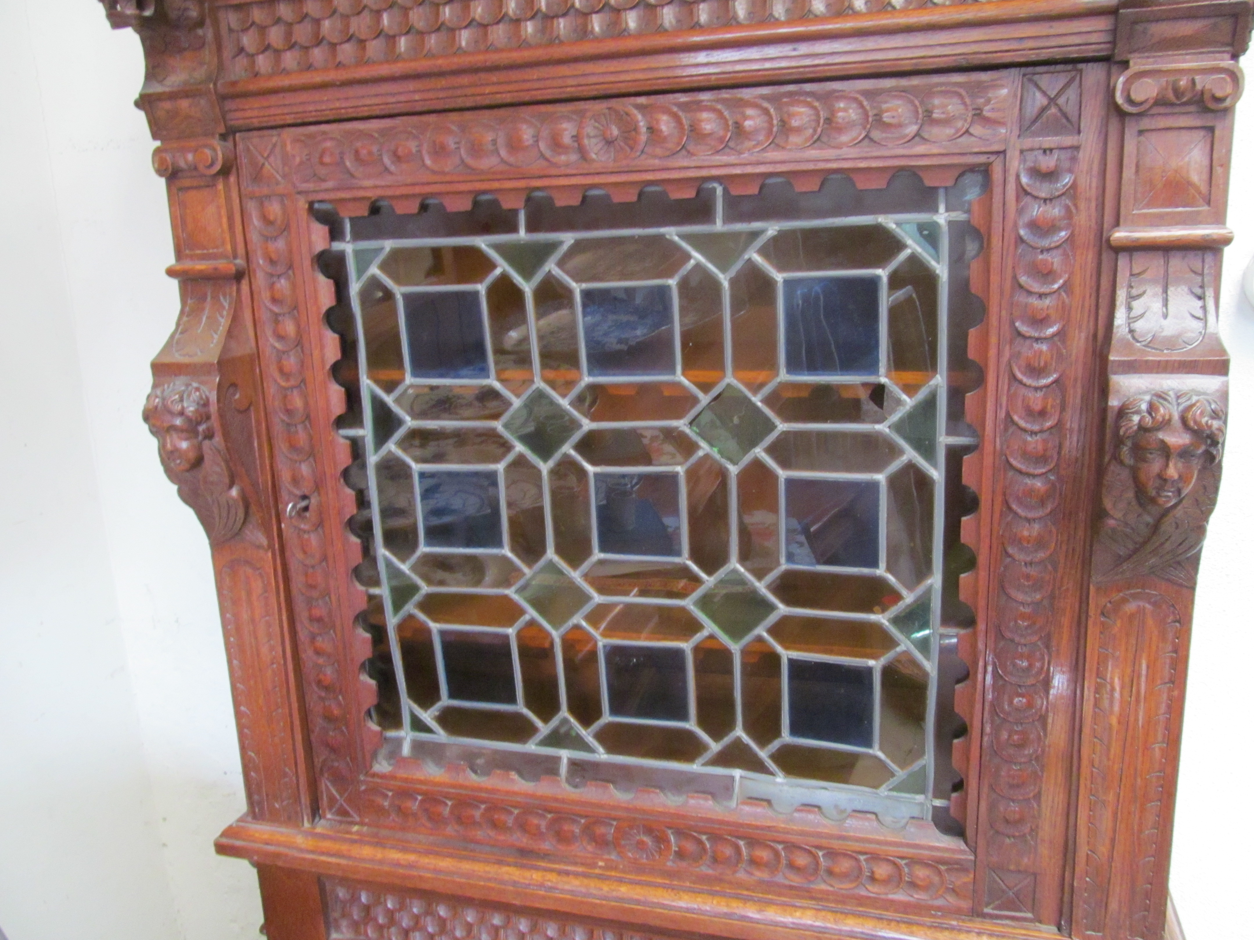 A continental oak cabinet with carved decoration, stained glass upper door and panelled door - Image 3 of 3
