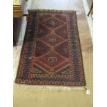 A Belouch style rug madder ground with central pole medallion