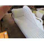 A white Chaise Longue with swan back