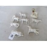 Various white china horses and Staffordshire dog