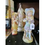 A coloured bisque model of a classical lady and two other bisque model of girls.