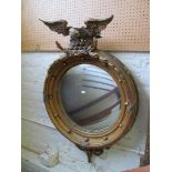 A 19th Century gilt convex mirror with eagle cresting.