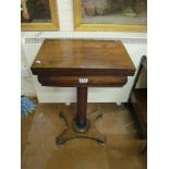 An early 19th Century rosewood work/games table with fold top on fluted supports and platform base