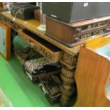 A large carved oak desk with carved edge, two frieze drawers and dummy en verso on bulbous legs