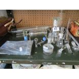 A quantity of laboratory glassware and surgical instruments.