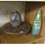 A treen stand, bottle and egg.