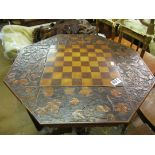 A Victorian games table with floral carving