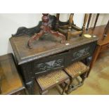 A carved oak two door sideboard with gallery