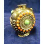 An oriental white metal and gem stone scent bottle embossed dragon