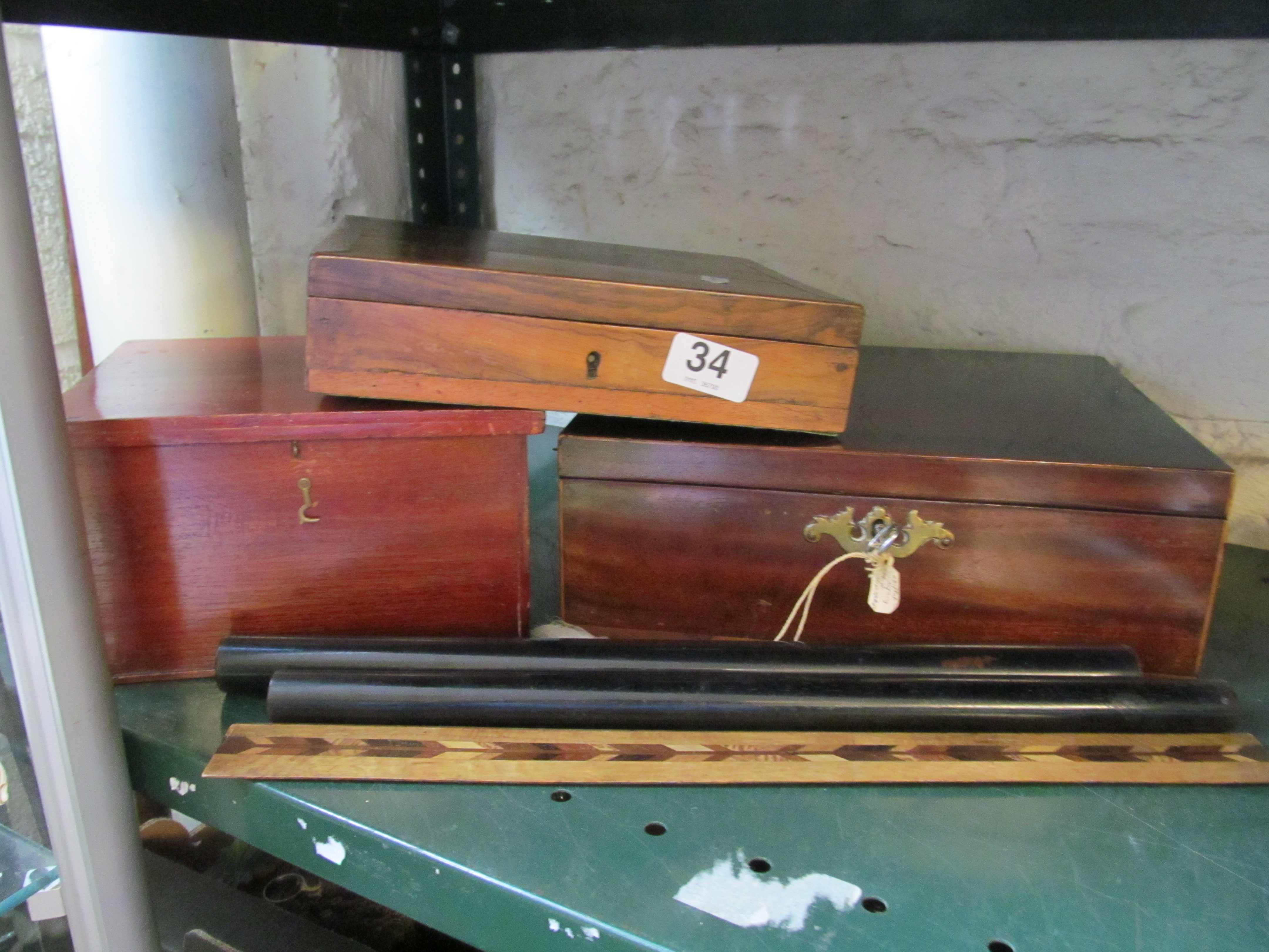 A mahogany box with tray liner, two other boxes and three rules