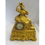 A 19th Century gilt bronze mantel clock surmounted by seated lady