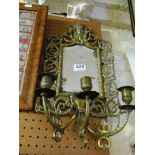 A brass girandole mirror.