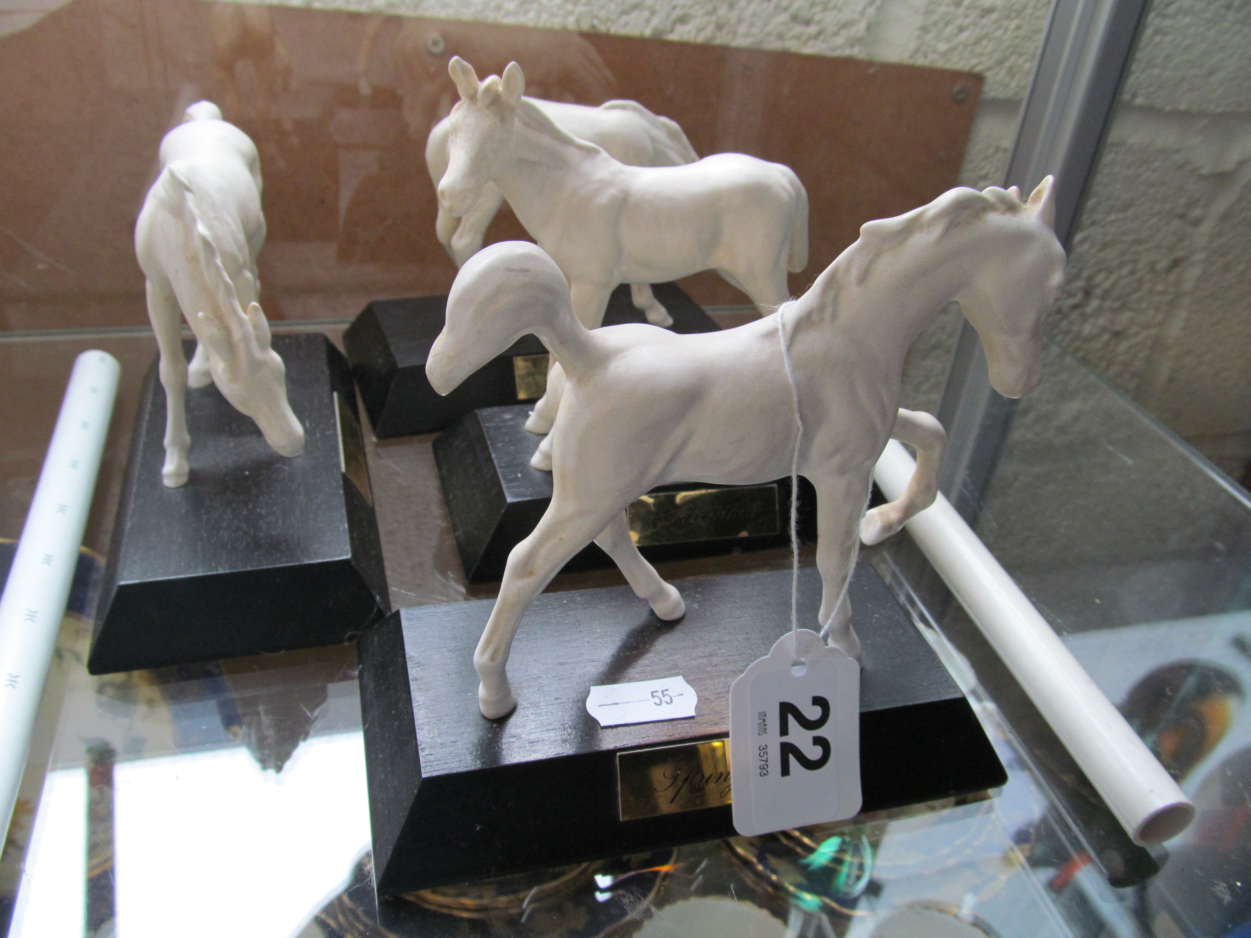 Four matt white Beswick horses on black bases