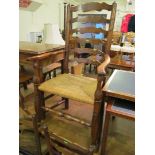 A set of four Lancashire style ladder back chairs and a similar carver chair