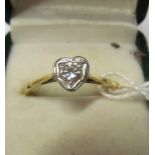 An 18ct gold and platinum heart ring with diamond setting.