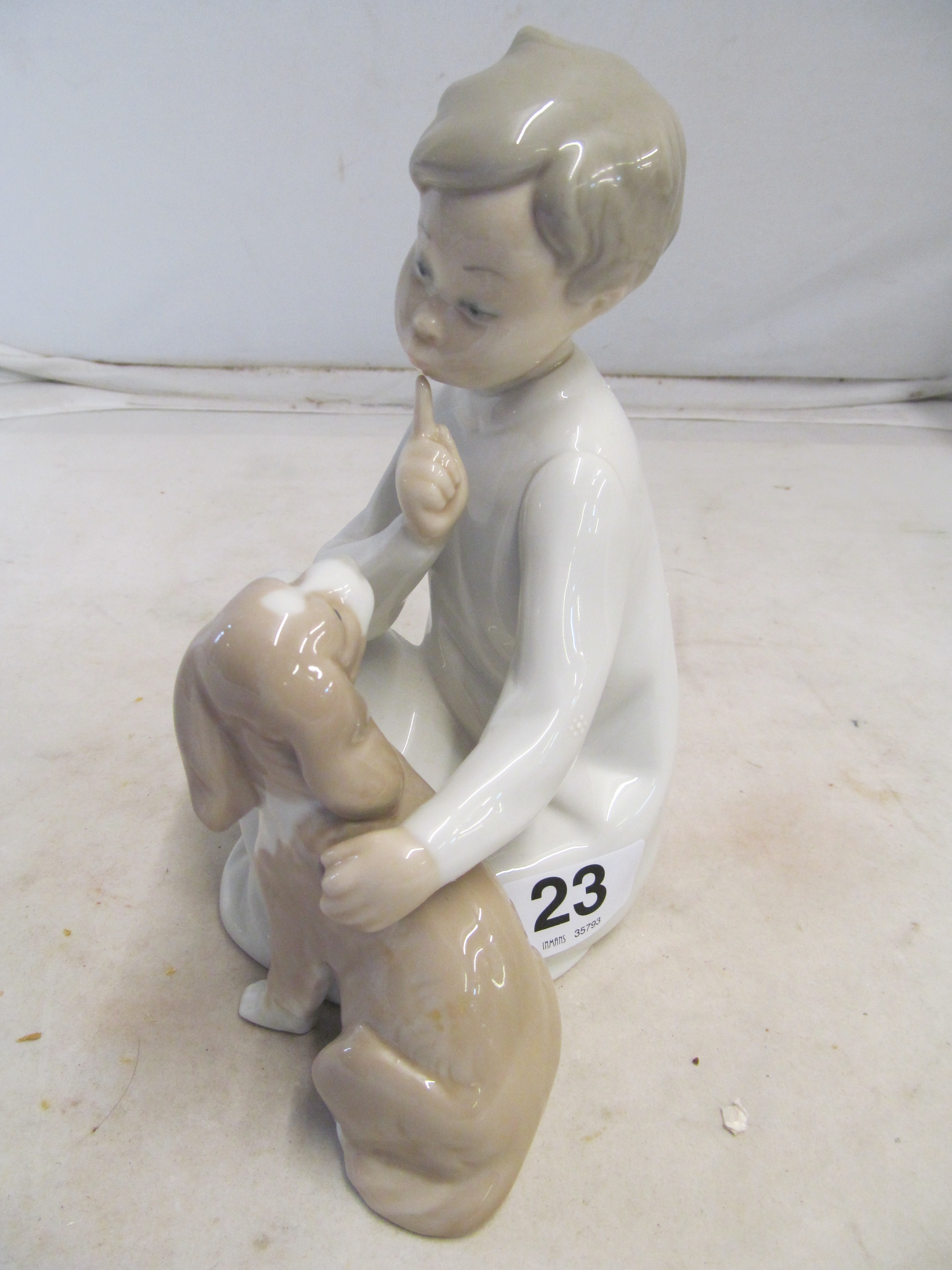 A Lladro boy with dog