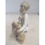 A Lladro boy with dog