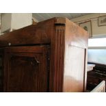 A continental armoire with shelves to sides.