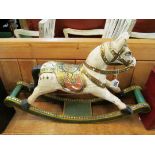 A carved small rocking horse.