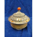 An eastern white metal, treen and gem stone lidded pot