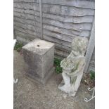 A garden statue of cherubs on concrete plinth.