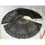 A Victorian black lace fan painted lady and cherubs, another with butterflies and another with