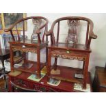 A pair of oriental shaped backed chairs with carvings of man and woman to back