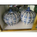 A pair of lidded oriental style vases.