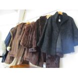 Three fur coats, two stoles, and two fur collar wraps.