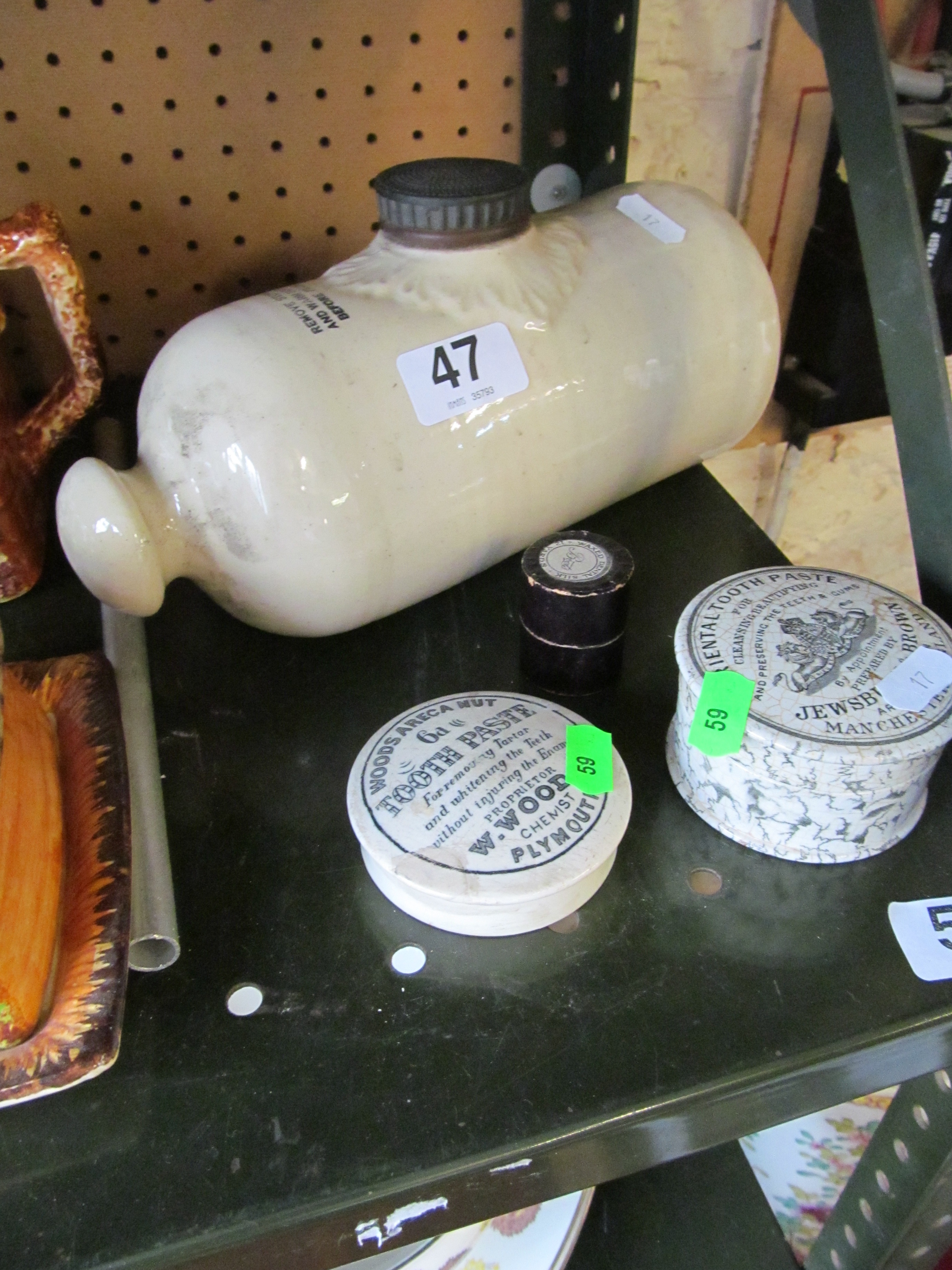 A stoneware hot water bottle, two Victorian advertising toothpaste pots and a dental silk pot