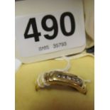 A gold ring set five small diamonds.