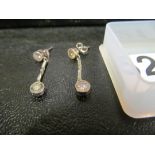 A pair of diamond set drop earrings.