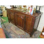 An antique French walnut sideboard with two cupboards on knurled feet.