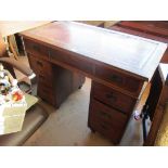 An antique campaign style pedestal desk on screw in feet