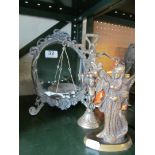 A freestanding mirror, set of scales and brass model of lady
