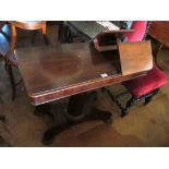 A Victorian mahogany invalid table with adjustable height and two adjustable flaps