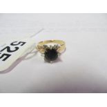 A 14ct gold blue stone and four small diamond ring